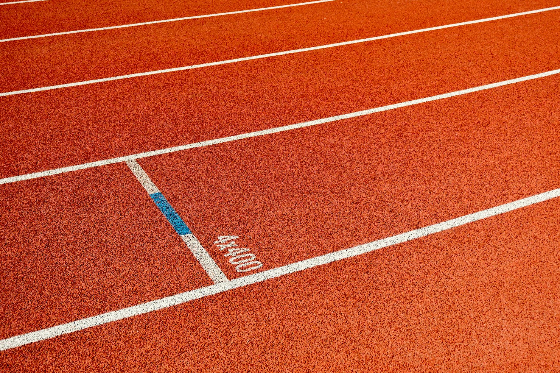 Detailed view of empty athletic track lanes, ideal for sports themes.