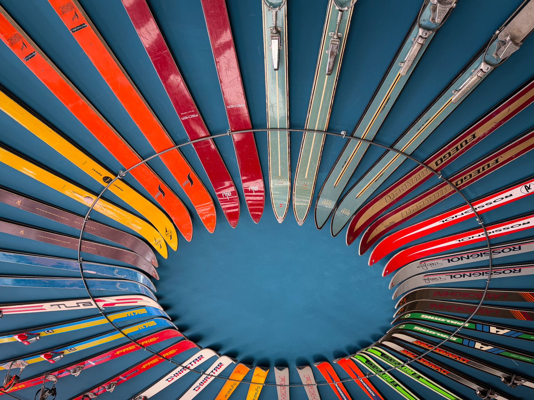 Vibrant vintage skis arranged in a circular pattern create a stunning visual display.