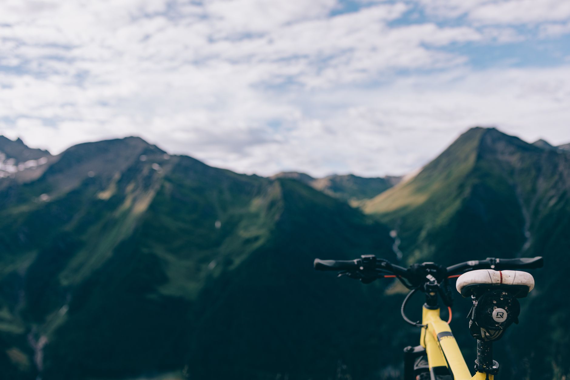 Explore breathtaking mountain landscapes with a close-up of a bicycle.
