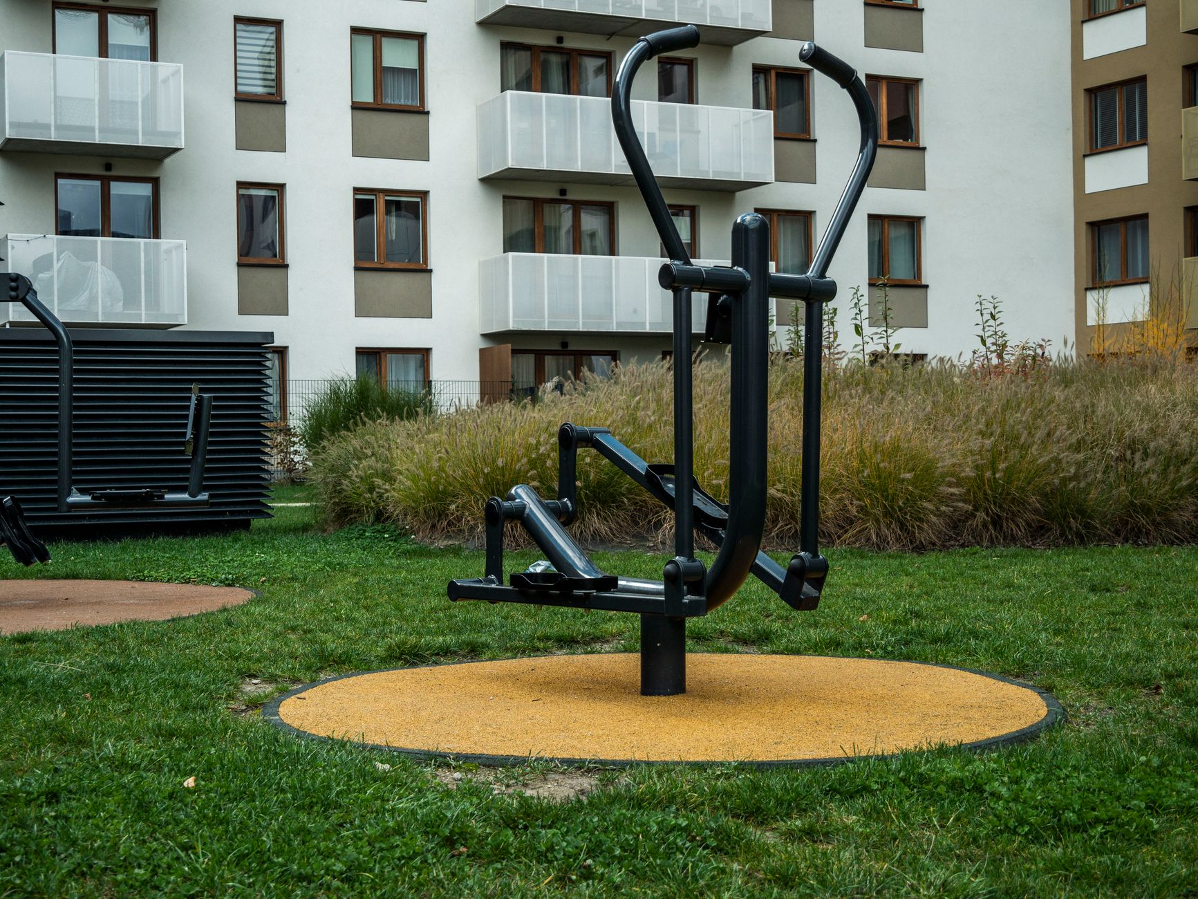 Outdoor gym equipment in a modern urban residential area, perfect for exercise.