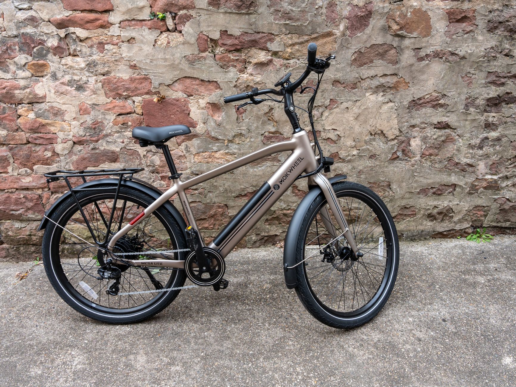 Stylish electric bicycle set against a rustic brick wall, showcasing urban design.