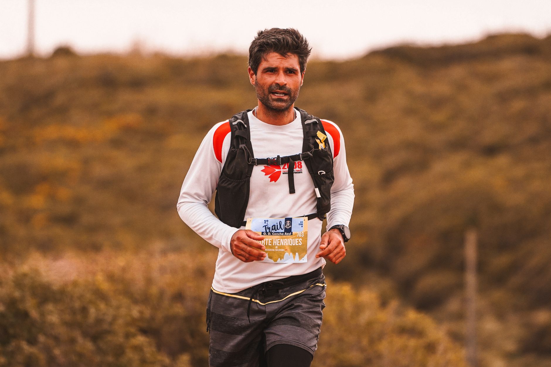 Trail runner with determination competing in an outdoor marathon event.