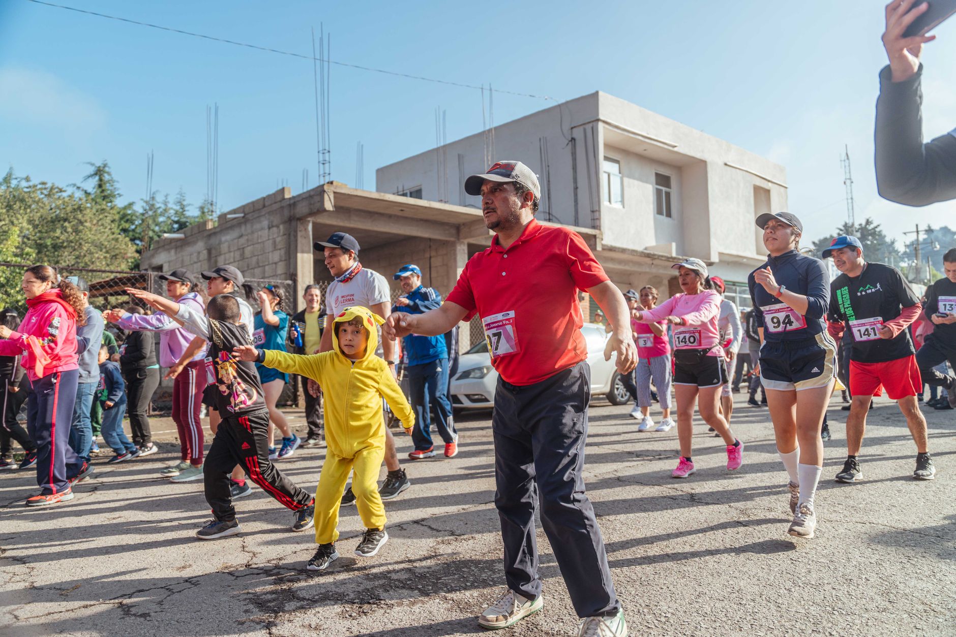 Local marathon event with diverse group of runners actively participating in a community race.