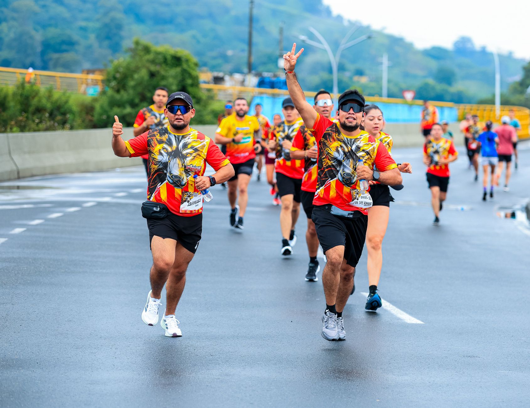 Group of runners in colorful attire energetically participating in a marathon outdoors.