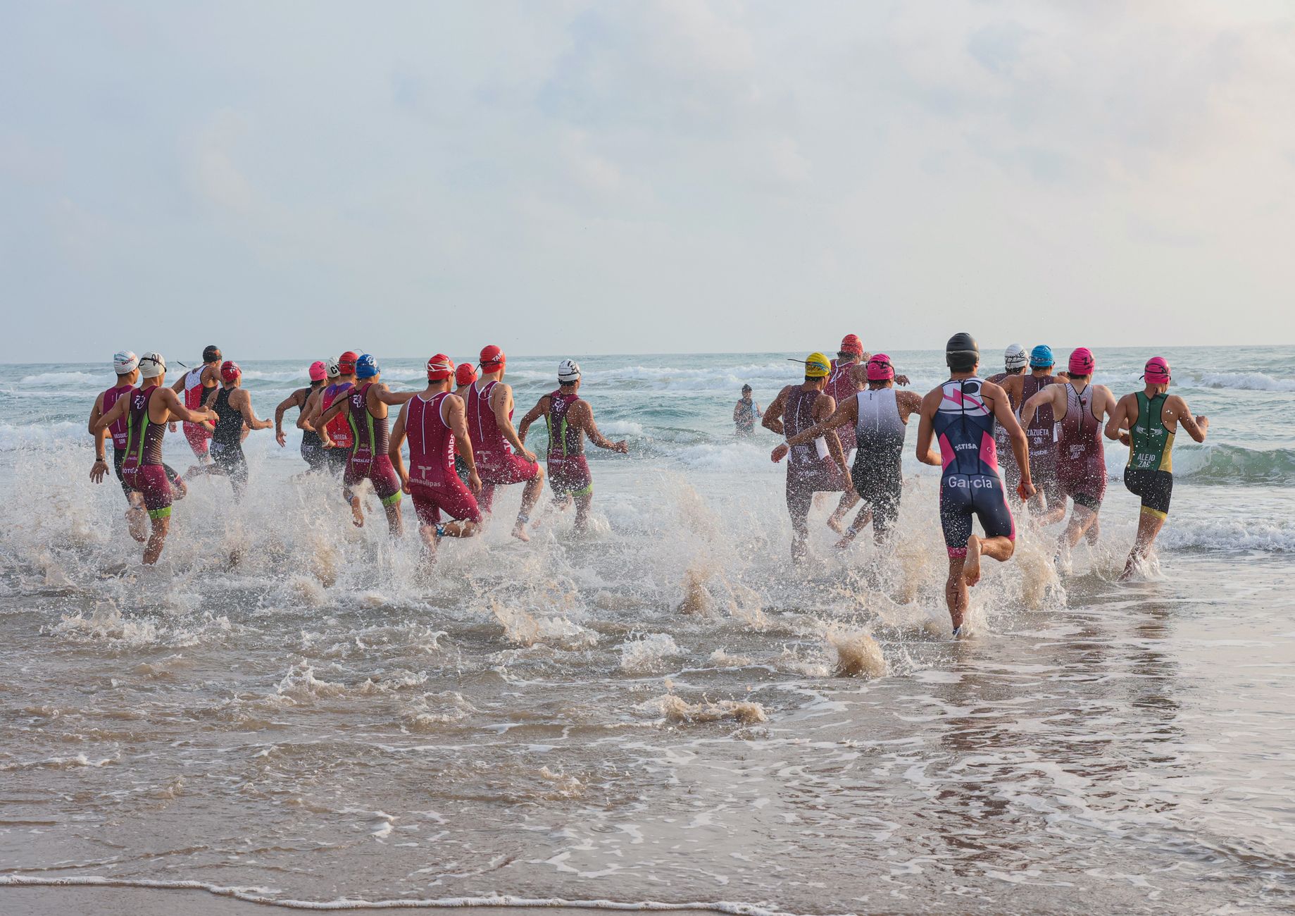 Group of triathletes starting ocean swim during a race in Ciudad Madero, Tamaulipas, Mexico.