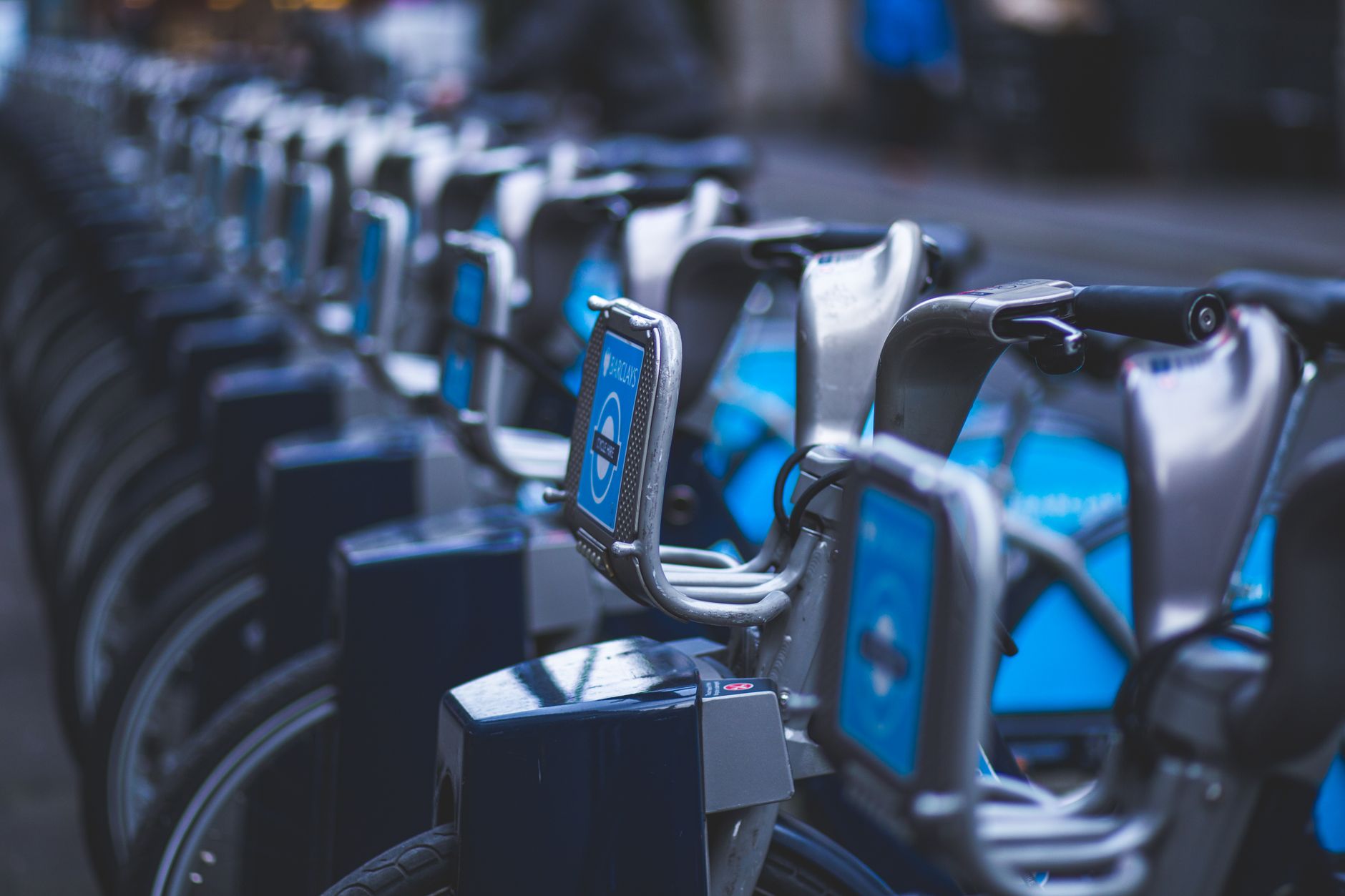 Row of bicycles at a public docking station for urban transportation.