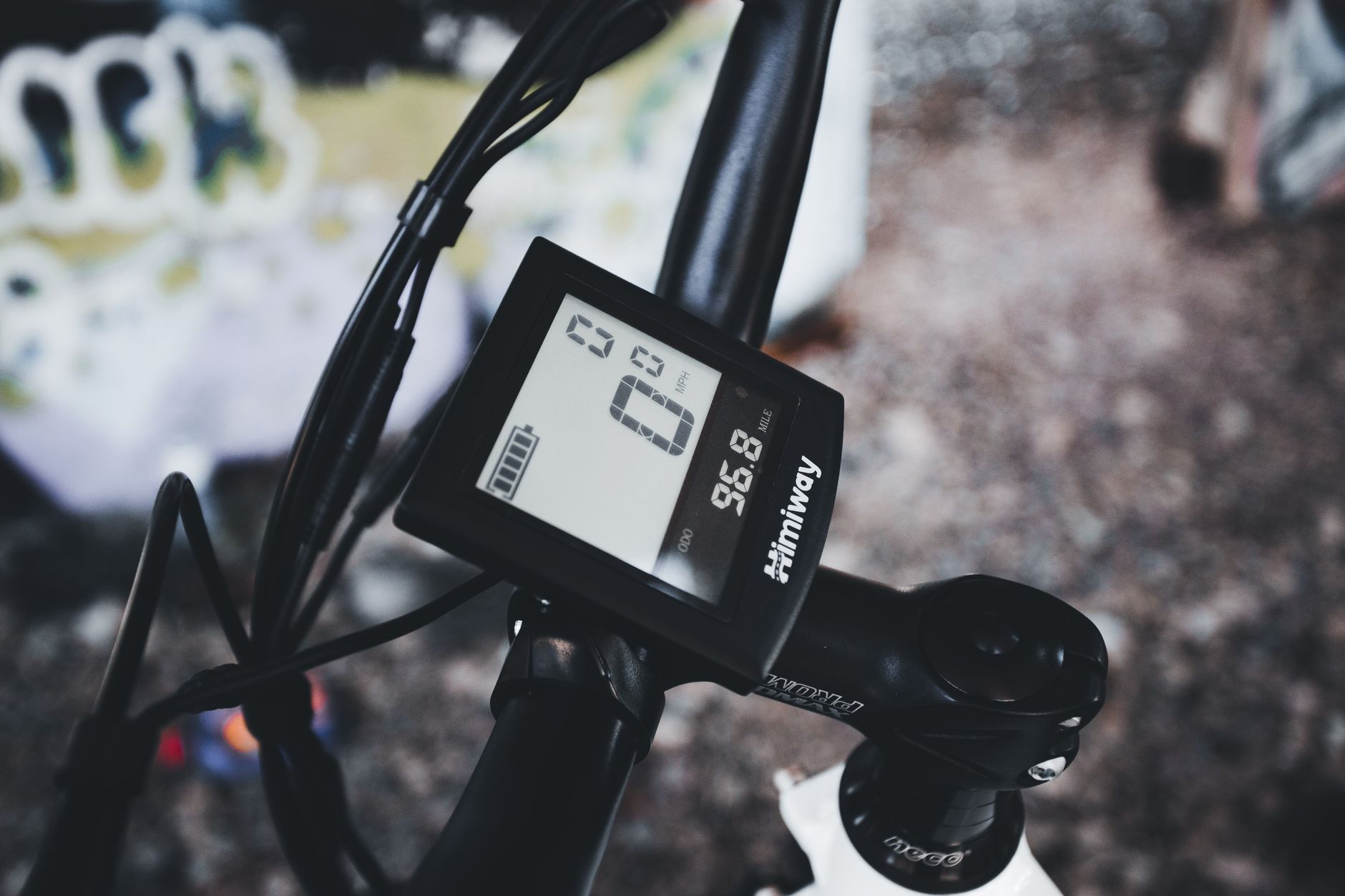 Detailed close-up of a bicycle handlebar featuring a digital speedometer display, emphasizing modern cycling technology.